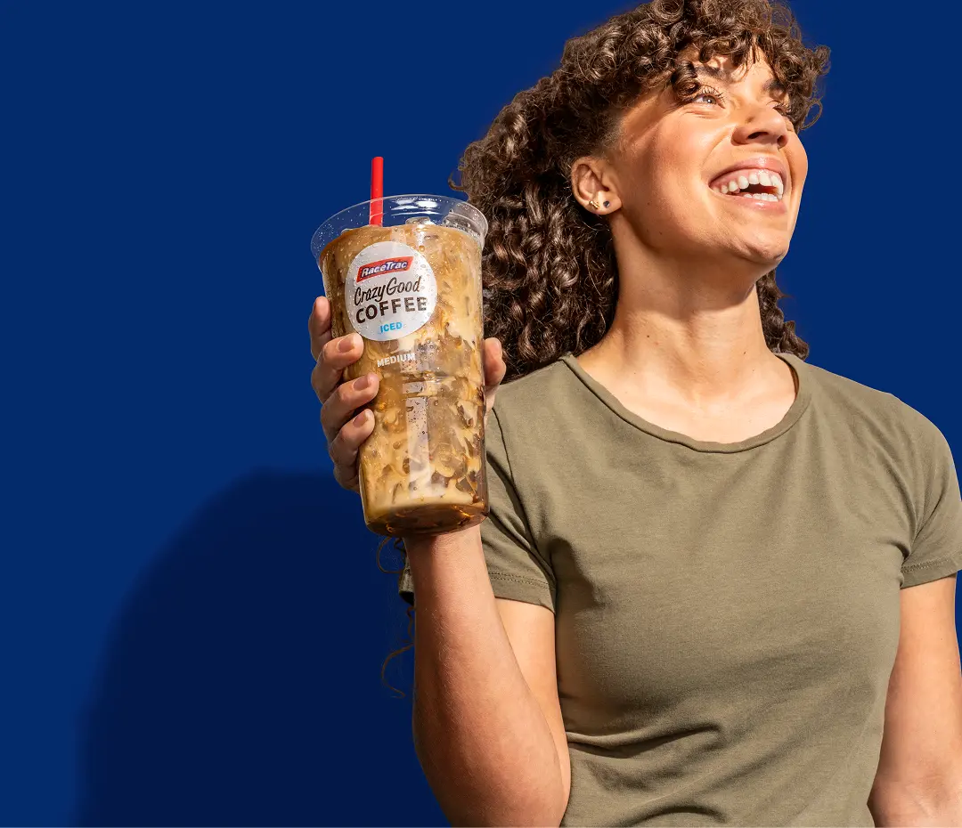 Woman holding an iced Crazy Good Coffee from RaceTrac