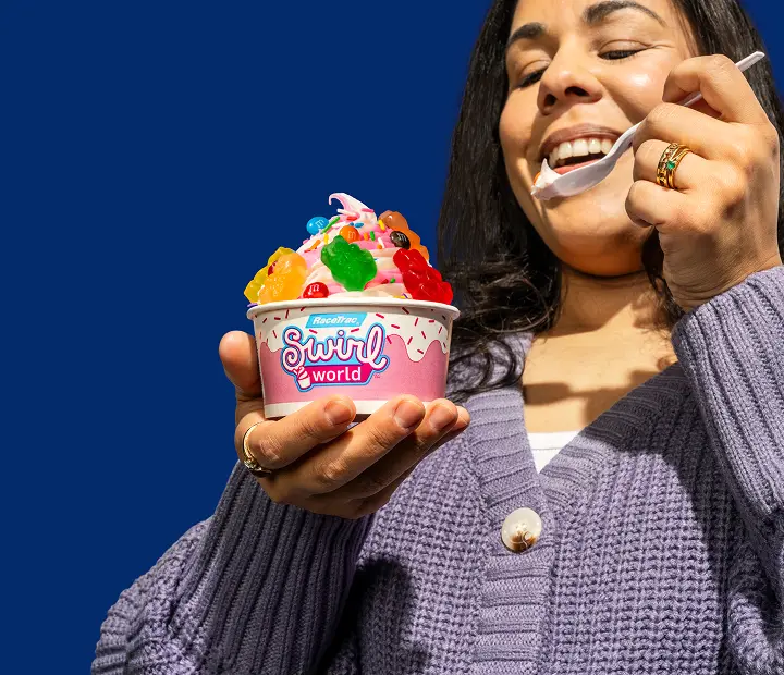 Woman eating Swirl World Frozen Yogurt