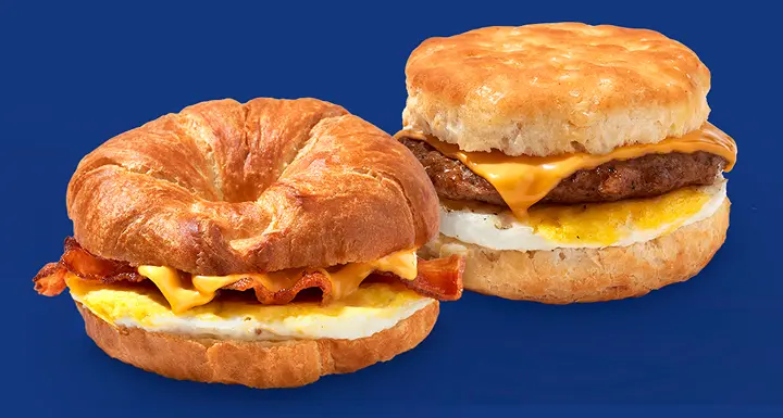 Bacon, egg, and cheese croissant and a sausage, egg, and cheese biscuit 